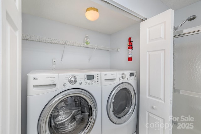 washroom with laundry area and washer and clothes dryer