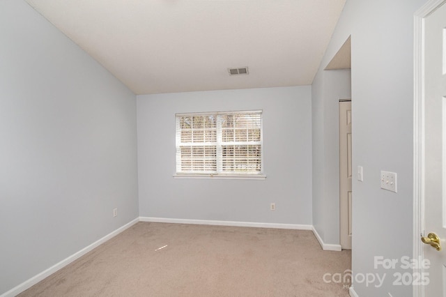 empty room with visible vents, baseboards, and carpet floors