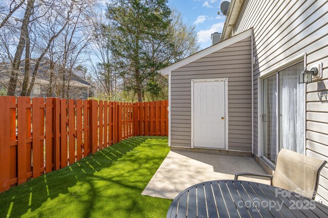 view of yard featuring a patio area and a fenced backyard