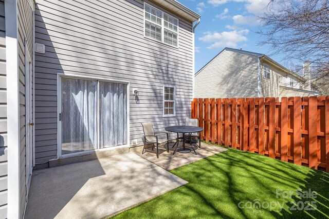 exterior space with a yard, fence, and a patio area