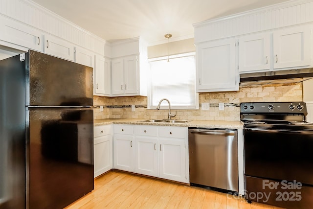 kitchen featuring a sink, black appliances, under cabinet range hood, white cabinetry, and crown molding