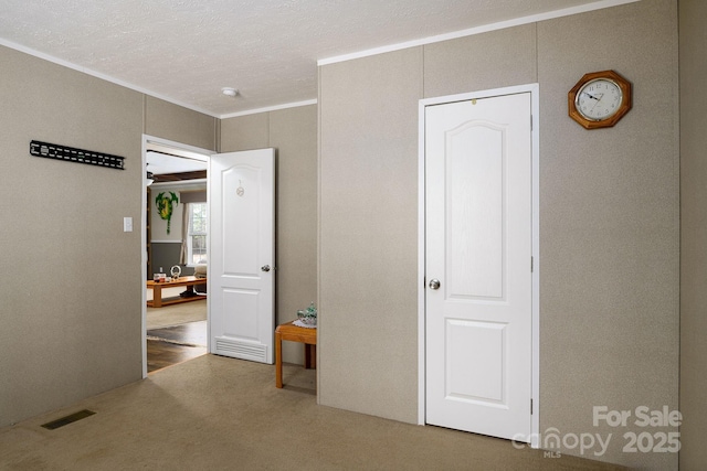 bedroom featuring visible vents, a textured ceiling, and ornamental molding