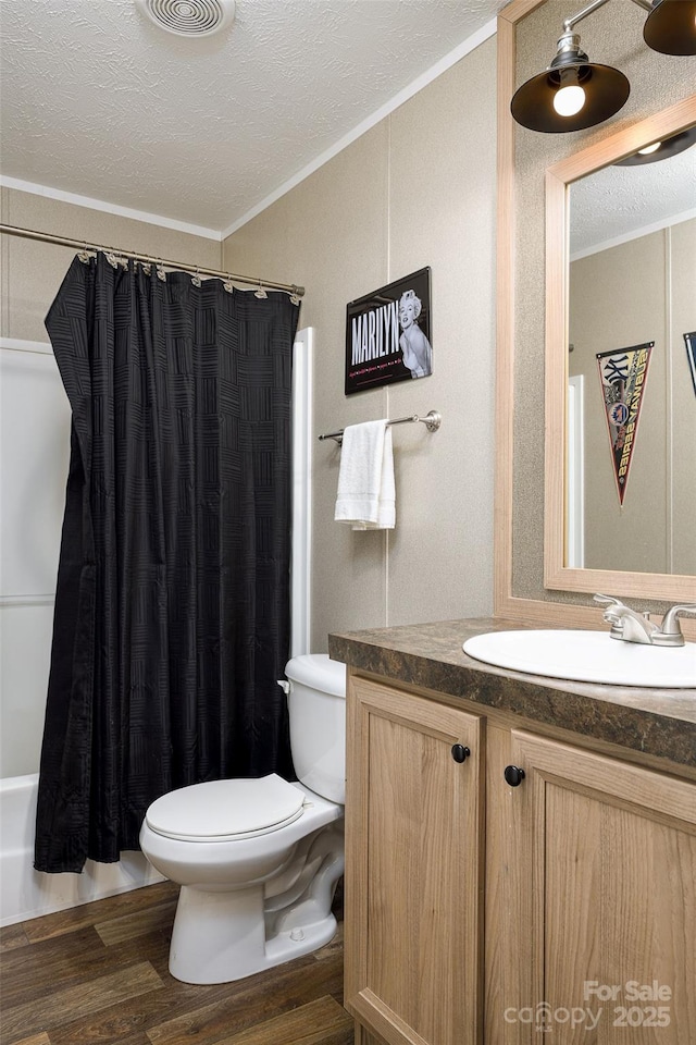 full bathroom featuring wood finished floors, toilet, vanity, and ornamental molding