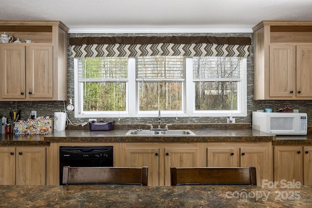 kitchen featuring white microwave, backsplash, light brown cabinetry, dishwasher, and a sink