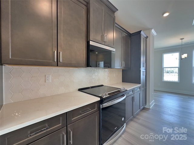 kitchen featuring crown molding, electric range, backsplash, and dark brown cabinetry