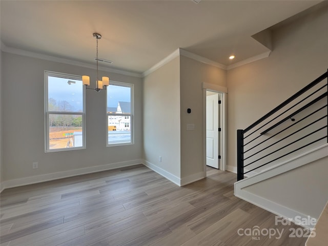 interior space with light wood finished floors, crown molding, baseboards, stairway, and an inviting chandelier