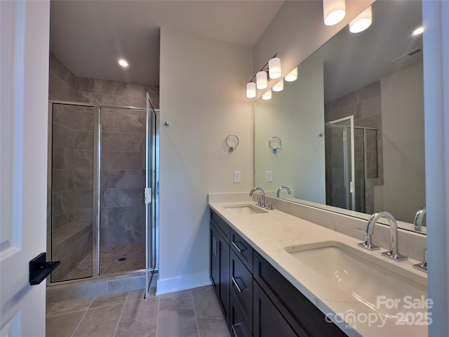 full bath featuring a sink, visible vents, a stall shower, and double vanity