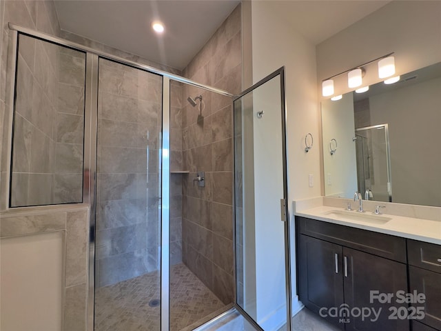 full bathroom with a shower stall and vanity