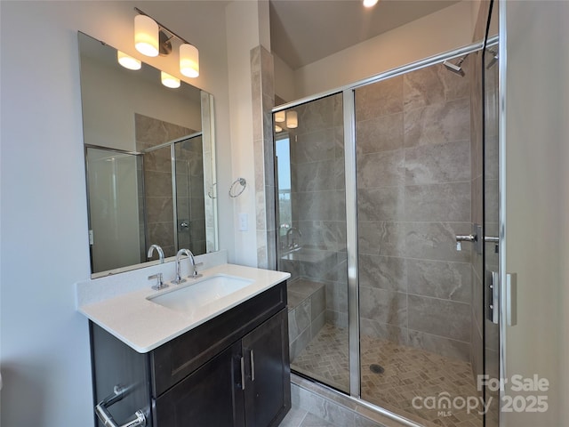 bathroom featuring vanity and a shower stall