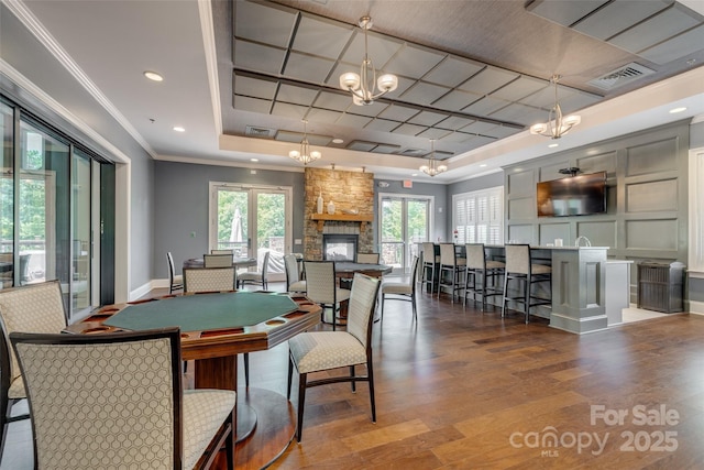 17436 Langston Dr, Charlotte, NC 28278 - dining space with a chandelier, a raised ceiling, wood finished floors, baseboards, and crown molding