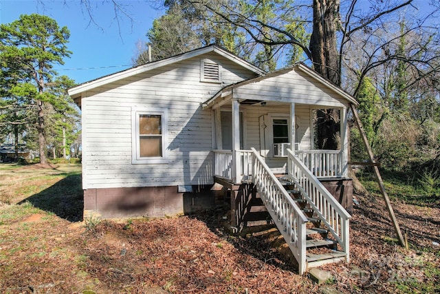 bungalow-style house featuring a porch and stairs