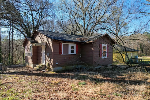 view of home's exterior with cooling unit and crawl space