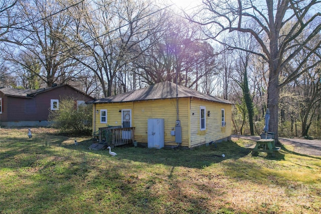 view of side of home featuring a lawn