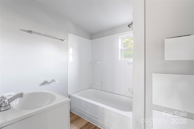 full bathroom featuring  shower combination and wood finished floors