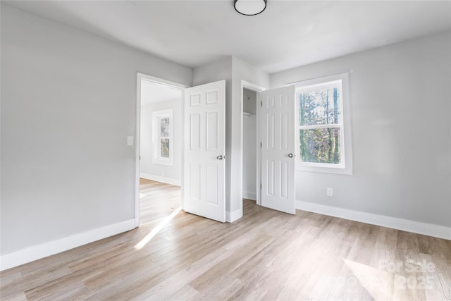 unfurnished bedroom featuring wood finished floors and baseboards