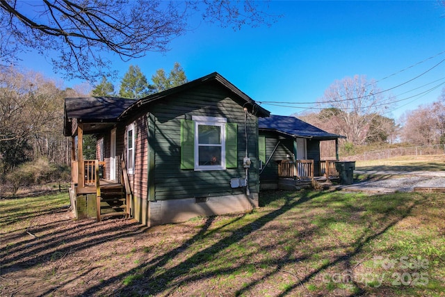 view of property exterior with crawl space and a yard