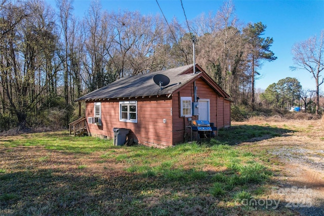 view of property exterior with a lawn