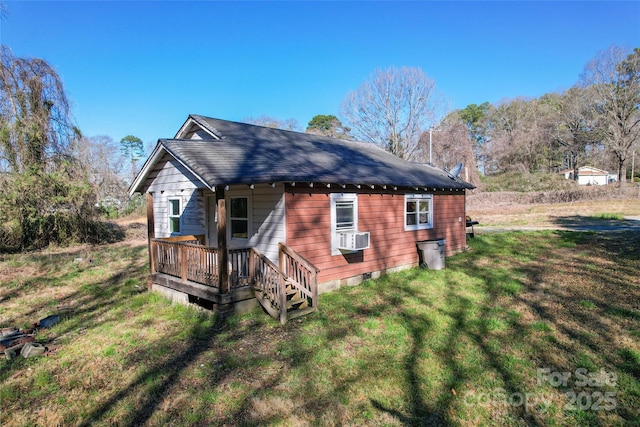 view of home's exterior featuring crawl space, a yard, roof with shingles, and a deck