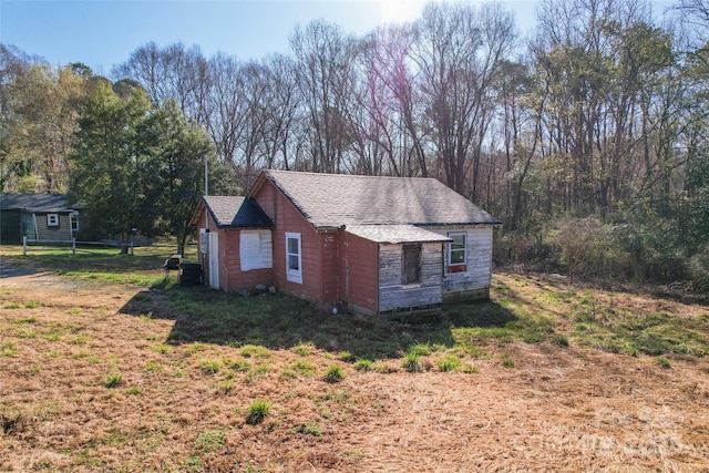 view of home's exterior with roof with shingles