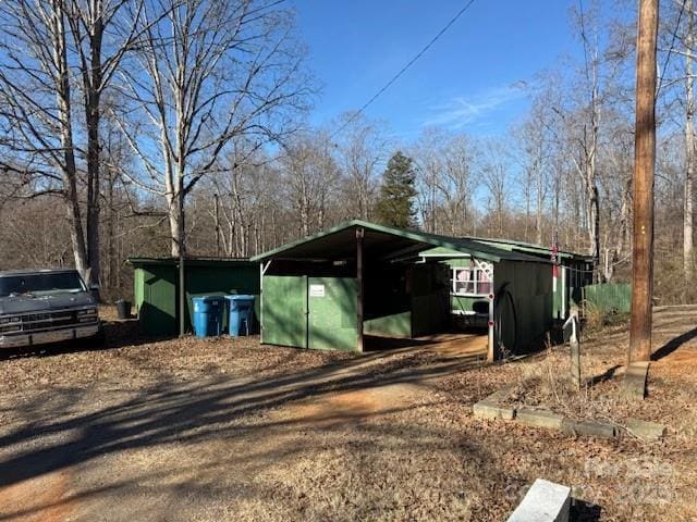 view of outbuilding with an outbuilding and dirt driveway