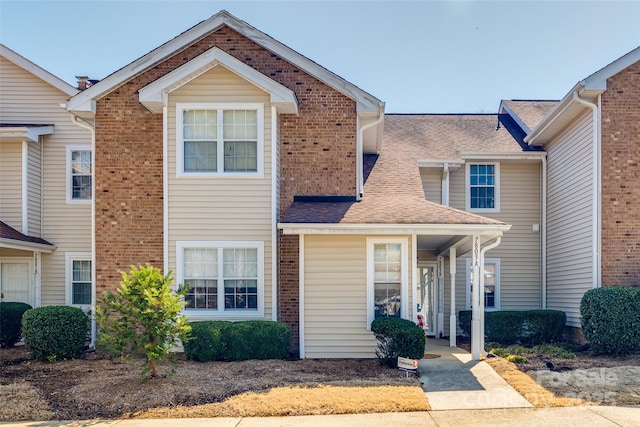 multi unit property featuring roof with shingles