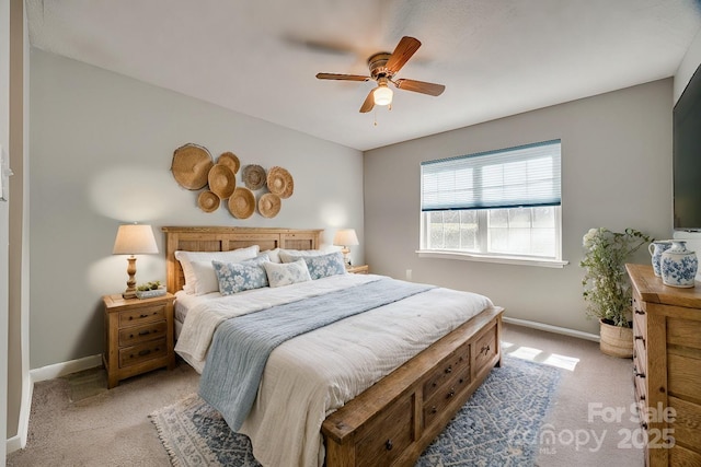 bedroom featuring baseboards, light carpet, and ceiling fan