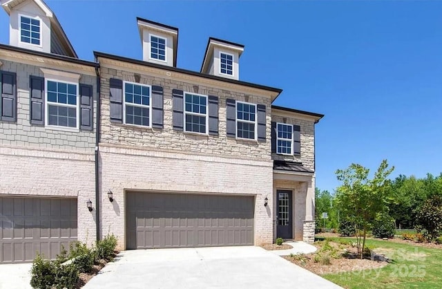 view of front of house with concrete driveway, a garage, and stone siding