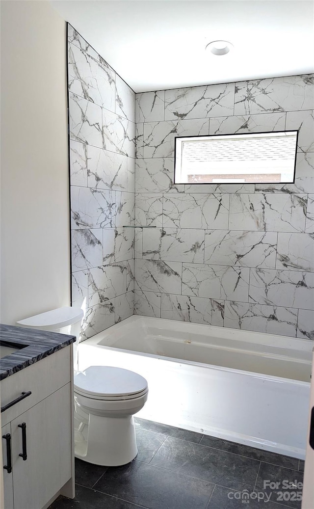 bathroom featuring tub / shower combination, toilet, and vanity