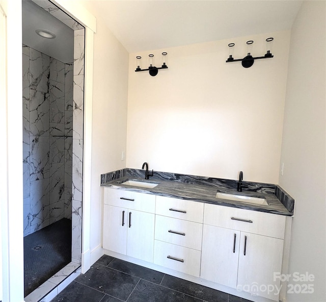 full bathroom with a sink, a marble finish shower, double vanity, and tile patterned flooring