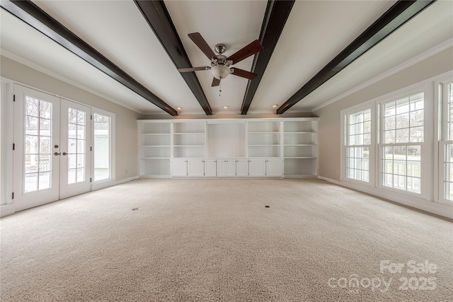 unfurnished living room featuring ornamental molding, ceiling fan, beamed ceiling, and light carpet