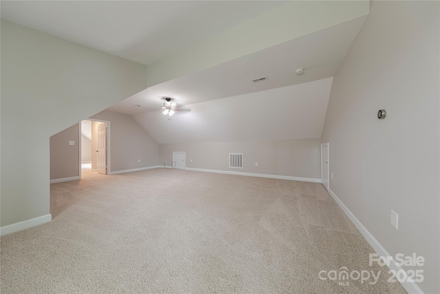 bonus room with light carpet, baseboards, lofted ceiling, and visible vents