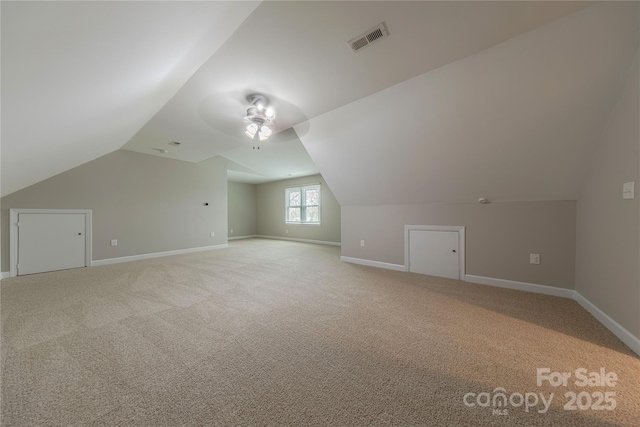 bonus room with vaulted ceiling, baseboards, carpet floors, ceiling fan, and visible vents