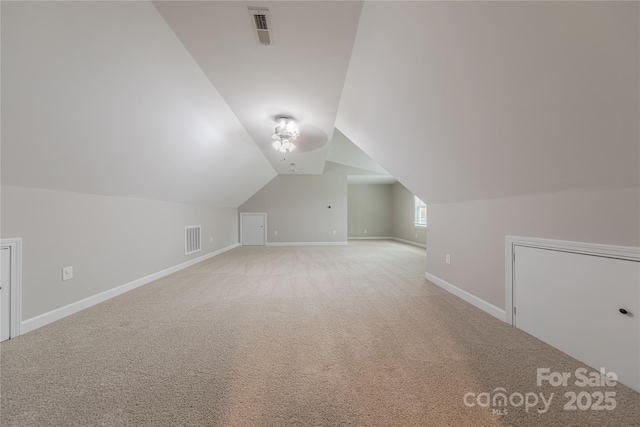 bonus room featuring light colored carpet, visible vents, and baseboards