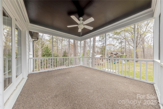 unfurnished sunroom with a ceiling fan