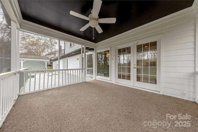 unfurnished sunroom with french doors and a ceiling fan