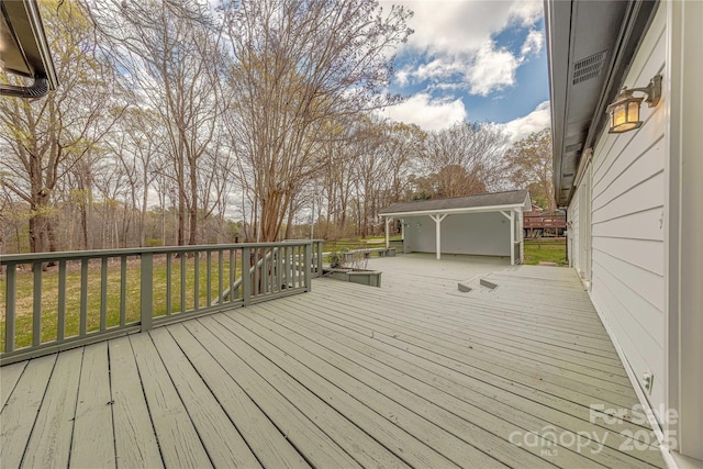 wooden terrace with a lawn
