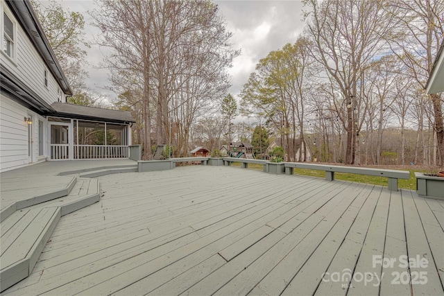 wooden deck with a sunroom