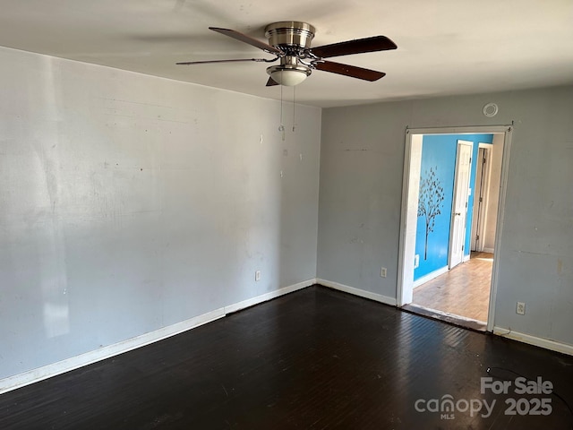 unfurnished room with ceiling fan, baseboards, and wood finished floors