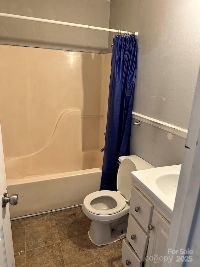 full bathroom featuring toilet, vanity, and shower / bath combination with curtain