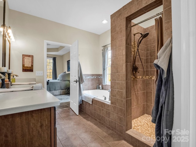 full bathroom featuring tile patterned floors, a garden tub, connected bathroom, tiled shower, and vanity