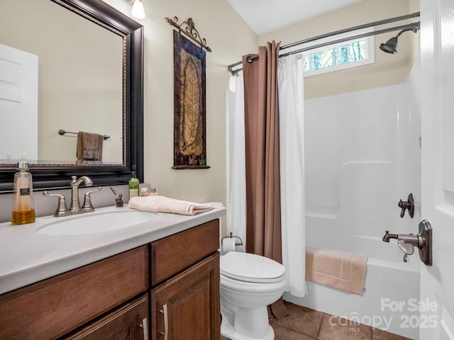 full bath with tile patterned floors, toilet, vanity, and shower / tub combo