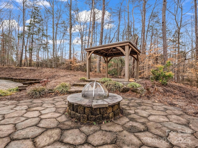 view of patio / terrace with a gazebo and a fire pit