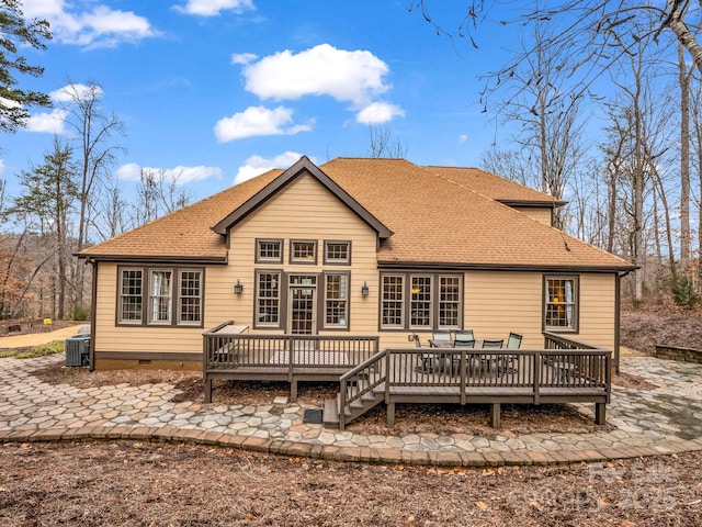 rear view of house featuring central air condition unit, a wooden deck, and a shingled roof