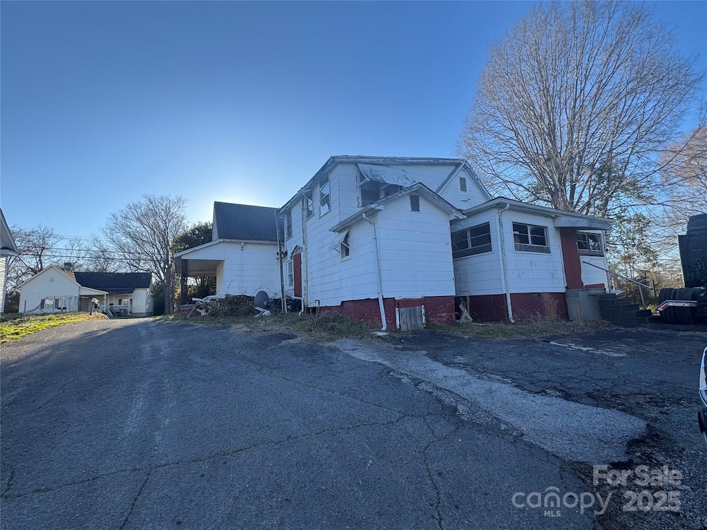 view of side of home with driveway