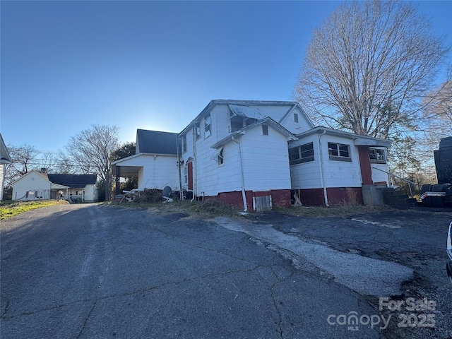 view of side of home with driveway