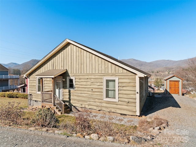 view of front of property with crawl space, a mountain view, and board and batten siding