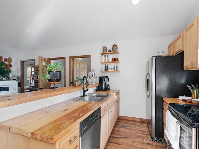 kitchen featuring open shelves, light wood-style flooring, a sink, wood counters, and dishwasher