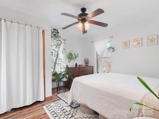 bedroom with wood finished floors and ceiling fan