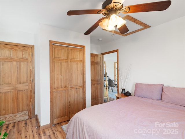 bedroom featuring a closet, light wood-type flooring, and ceiling fan