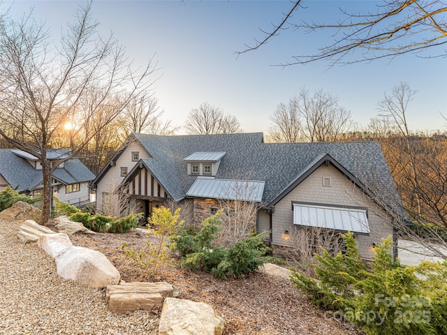 view of front of home with stone siding and a shingled roof